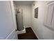 The utility room boasts a water heater and an electrical panel on dark wood-look flooring at 1551 Crescent Townes Way, Raleigh, NC 27604