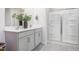 Elegant bathroom featuring a double vanity, framed mirror, and a modern glass-enclosed shower at 1752 Post Oak Dr, Haw River, NC 27258
