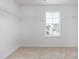 Walk-in closet boasting white walls and shelving with a window view of the neighborhood at 1752 Post Oak Dr, Haw River, NC 27258
