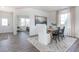 Bright dining room features a wooden table, white chairs, and a decorative rug creating an inviting atmosphere at 1752 Post Oak Dr, Haw River, NC 27258