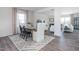 Dining room featuring a wooden table, stylish chairs, neutral drapes, a patterned rug, and a view to the living room at 1752 Post Oak Dr, Haw River, NC 27258