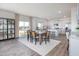 Bright dining area with an open floor plan, table with seating, and access to the kitchen and backyard at 1752 Post Oak Dr, Haw River, NC 27258
