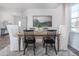 Dining room featuring a wooden table, stylish chairs, neutral drapes, a patterned rug, and wall decor at 1752 Post Oak Dr, Haw River, NC 27258