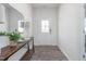 A welcoming entryway featuring a decorative front door, stylish console table, mirror, rug and wood flooring at 1752 Post Oak Dr, Haw River, NC 27258