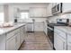 Well-lit kitchen featuring stainless steel appliances, granite countertops, and stylish cabinetry at 1752 Post Oak Dr, Haw River, NC 27258