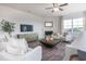 Cozy living room with fireplace, plush seating, and a large window, providing ample light and a relaxing space at 1752 Post Oak Dr, Haw River, NC 27258