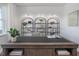 Bright home office featuring modern shelves with decor and books, and a beautiful desk with a potted plant at 1752 Post Oak Dr, Haw River, NC 27258