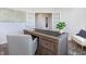 Bright home office featuring modern shelves, a beautiful desk, a chair, french doors and a stylish area rug at 1752 Post Oak Dr, Haw River, NC 27258