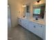 Bright bathroom features double vanity, tiled floors and a large framed mirror at 190 Sage Ln # 015, Four Oaks, NC 27524