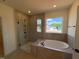 Modern bathroom showcasing a large walk-in shower and a separate soaking tub at 190 Sage Ln # 015, Four Oaks, NC 27524