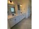 Elegant bathroom with dual sinks, granite countertops, and white cabinetry at 190 Sage Ln # 015, Four Oaks, NC 27524