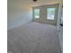 A carpeted bedroom with two windows at 190 Sage Ln # 015, Four Oaks, NC 27524