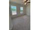 Well-lit bedroom featuring two windows and a ceiling fan, complete with neutral carpeting at 190 Sage Ln # 015, Four Oaks, NC 27524