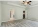 Spacious primary bedroom with neutral carpet, tray ceiling, ceiling fan, and ensuite bathroom at 190 Sage Ln # 015, Four Oaks, NC 27524