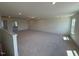 Open concept bonus room with neutral carpet and large window bringing in natural light at 190 Sage Ln # 015, Four Oaks, NC 27524