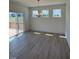 Bright dining area with sliding glass doors to the deck and modern light fixture at 190 Sage Ln # 015, Four Oaks, NC 27524