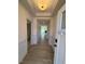 Bright foyer with light-colored wood floors and white wainscoting, leading into an open floor plan at 190 Sage Ln # 015, Four Oaks, NC 27524