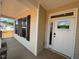 Inviting front porch with stone base columns and white trim around the windows and the front door at 190 Sage Ln # 015, Four Oaks, NC 27524
