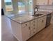 Kitchen island featuring granite countertops, stainless steel appliances, and ample cabinet space at 190 Sage Ln # 015, Four Oaks, NC 27524