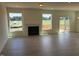 Inviting living room featuring large windows with natural light, fireplace, and access to deck at 190 Sage Ln # 015, Four Oaks, NC 27524