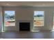 Bright living room with fireplace between two windows and walkout to deck at 190 Sage Ln # 015, Four Oaks, NC 27524
