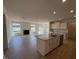 Open concept living space with a kitchen island, a fireplace, and a large sliding glass door at 190 Sage Ln # 015, Four Oaks, NC 27524