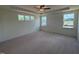 Spacious main bedroom with tray ceilings, ceiling fan and large windows for natural light at 190 Sage Ln # 015, Four Oaks, NC 27524