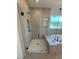 Modern walk-in shower with a frameless glass door and tiled walls in a bathroom at 190 Sage Ln # 015, Four Oaks, NC 27524