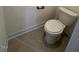 Close-up of a standard toilet in a bathroom setting, featuring neutral tiling at 190 Sage Ln # 015, Four Oaks, NC 27524