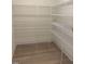 Open walk-in closet features an abundance of white metal shelving at 190 Sage Ln # 015, Four Oaks, NC 27524