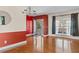 Bright entryway with hardwood floors, chandelier, and a view of the front porch through the glass door at 20 Argent Ct, Youngsville, NC 27596