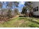 Picturesque backyard with lush green grass, mature trees, and a wooden deck at 200 Indian Elm Ln, Cary, NC 27519