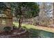 Backyard view featuring a small tree with landscaped stone border at 200 Indian Elm Ln, Cary, NC 27519