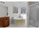 Bathroom with corner bathtub, walk-in shower and tile flooring at 200 Indian Elm Ln, Cary, NC 27519
