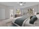 Bright bedroom features large windows, ceiling fan and ensuite bathroom at 200 Indian Elm Ln, Cary, NC 27519