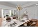 Bright dining room featuring a marble table, chandelier, and an open view to the living room at 200 Indian Elm Ln, Cary, NC 27519