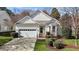 Inviting home exterior featuring a well-kept lawn, bay window, and attached two-car garage at 200 Indian Elm Ln, Cary, NC 27519