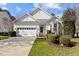 Charming single-story home with a manicured lawn, two car garage and a welcoming entrance at 200 Indian Elm Ln, Cary, NC 27519