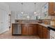 Functional kitchen area with a stainless steel dishwasher and wooden cabinets at 200 Indian Elm Ln, Cary, NC 27519