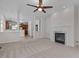 Open living room with fireplace and view to the kitchen with center island at 200 Indian Elm Ln, Cary, NC 27519