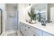 Elegant bathroom with dual sinks, white cabinetry, modern fixtures, and a large mirror at 209 Deodora Ln, Cameron, NC 28326