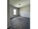 Carpeted bedroom featuring neutral walls, natural light from a window, and ample space at 209 Deodora Ln, Cameron, NC 28326