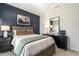 Bedroom with a bed, a dark blue accent wall, decorative lamps, and soft, neutral colored bedding at 209 Deodora Ln, Cameron, NC 28326