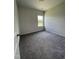 Carpeted bedroom featuring neutral walls, a window, and a standard ceiling light at 209 Deodora Ln, Cameron, NC 28326