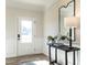 Entryway with wood floors, black console table, decorative mirror, and modern lamp at 209 Deodora Ln, Cameron, NC 28326