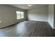 Spacious living room featuring hardwood floors, neutral paint, and a bright window at 209 Deodora Ln, Cameron, NC 28326