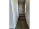 Carpeted stairway with wood-look flooring at the base and neutral paint, leading to the upper level at 209 Deodora Ln, Cameron, NC 28326