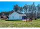 Spacious backyard with mature trees, a screened porch, and a swing for relaxing and enjoying the outdoors at 2105 Antioch Church Rd, Timberlake, NC 27583