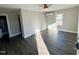 Bright room with gray floors, ceiling fan, white trim, and a window at 212 Craig Ave, Henderson, NC 27537
