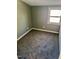 Small bedroom with gray walls and neutral carpet gets natural light from the single window at 212 Craig Ave, Henderson, NC 27537